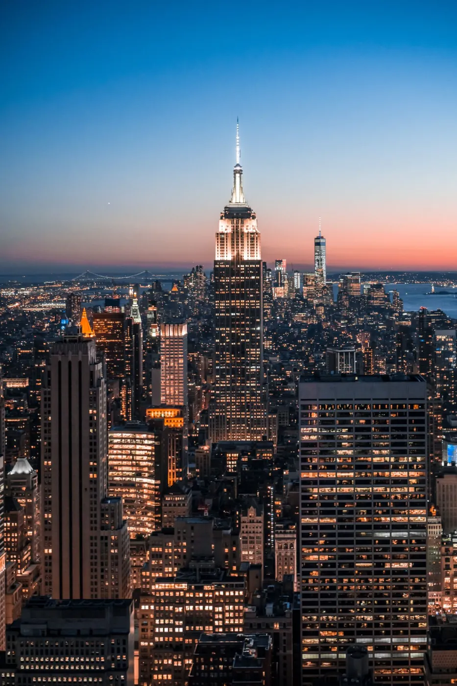 The Manhattan skyline at dusk with the Empire State Building lit up